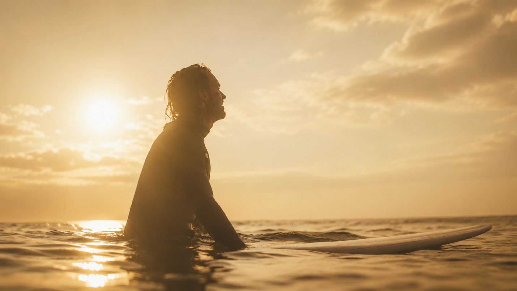 A man rising from the water at first light